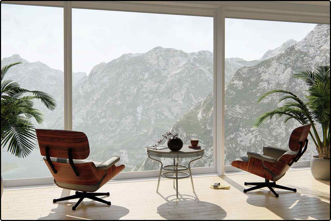 Interior room with a relaxing hill view from the large glass windows with chair and table